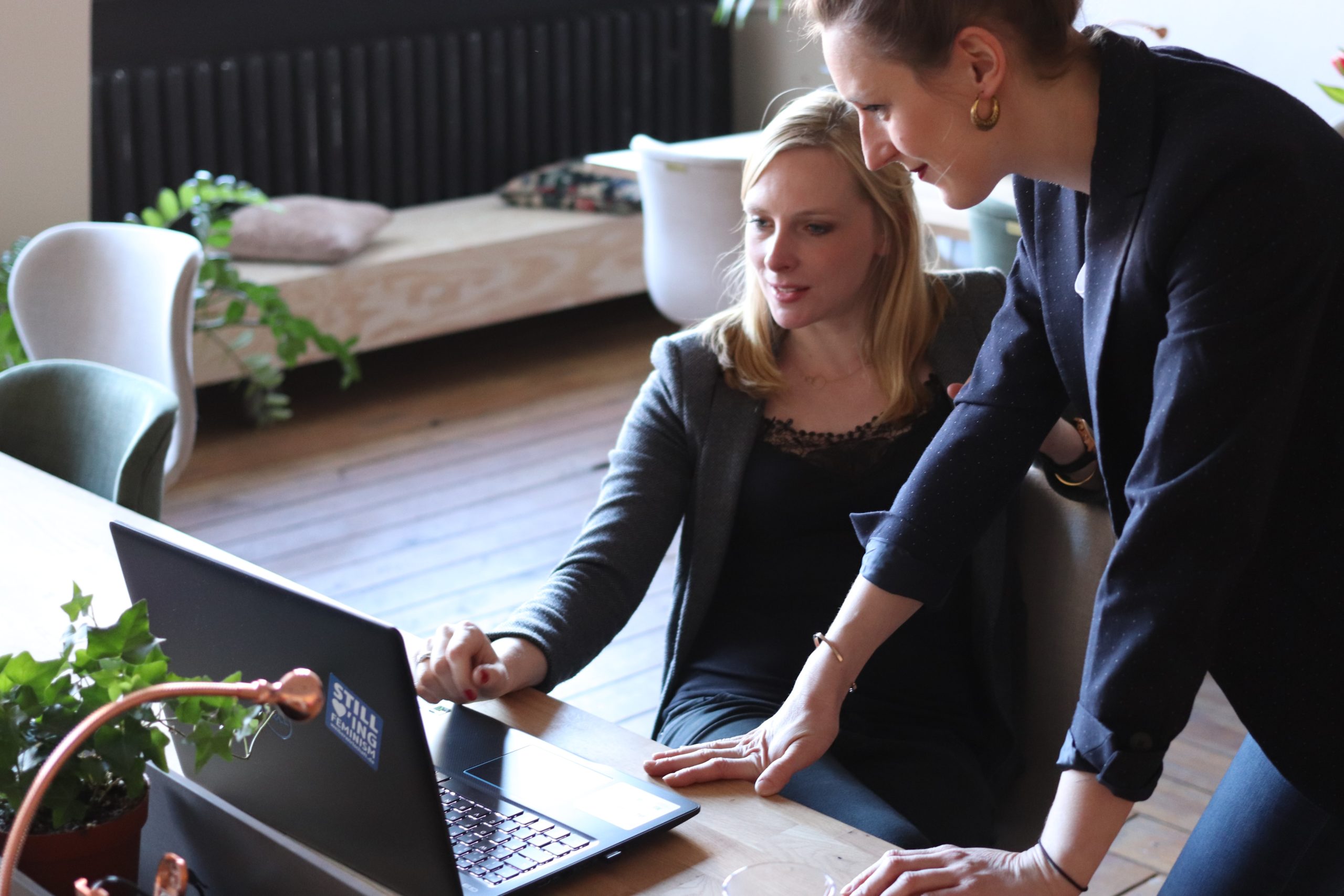 Two people in front of a laptop